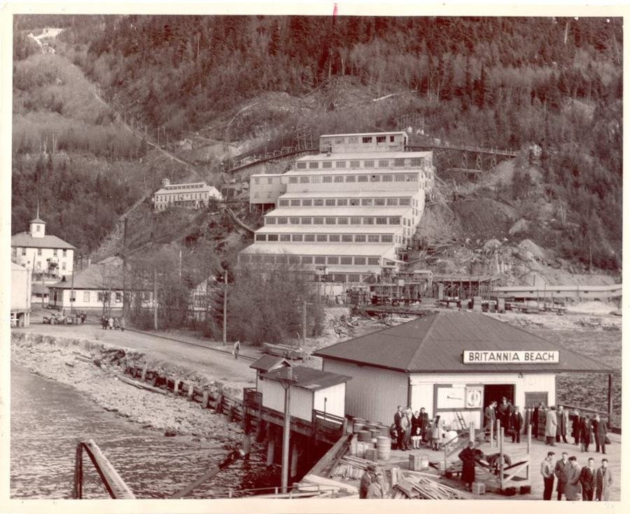 Historic photograph of the Britannia Beach mill buildings on the hillside above the wharf